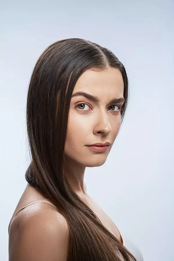 beautiful woman posing on the gray background